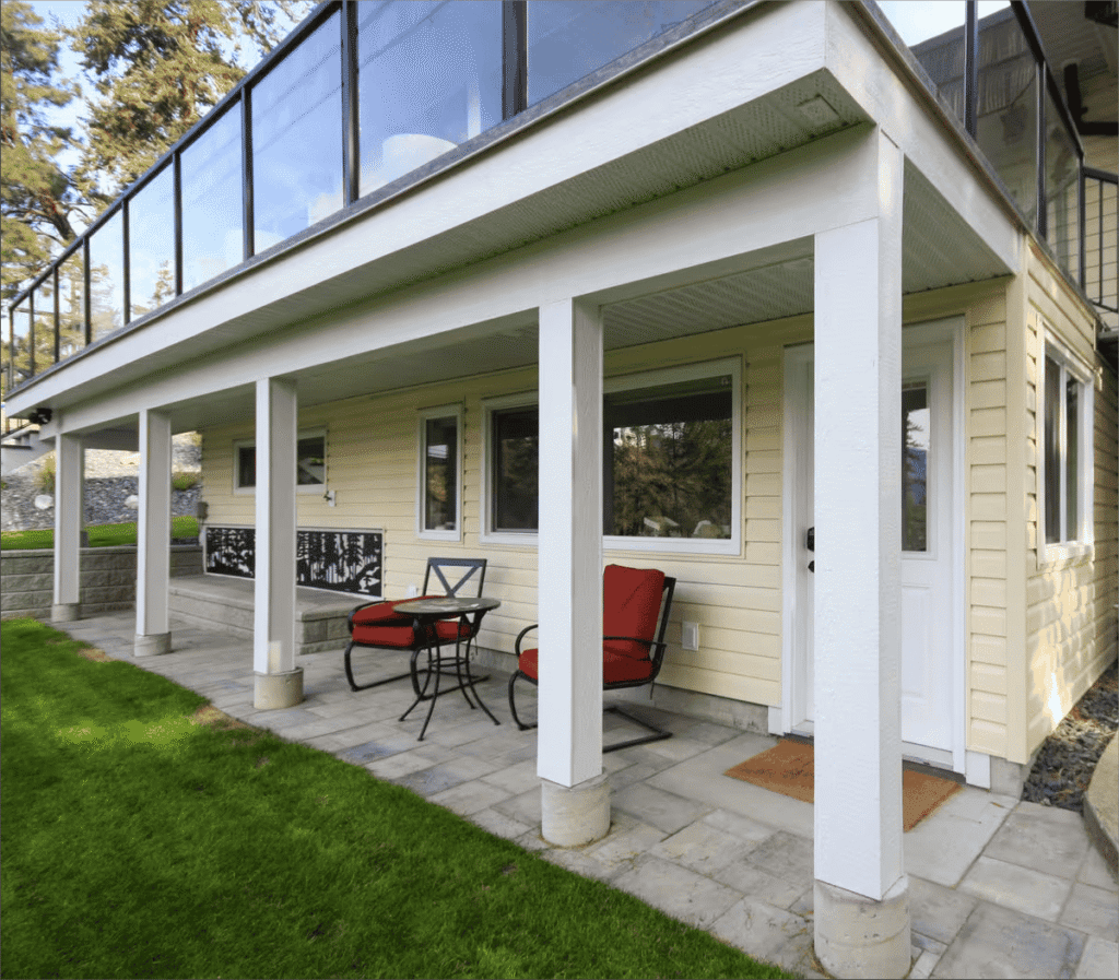 Cozy backyard patio with chairs and table.